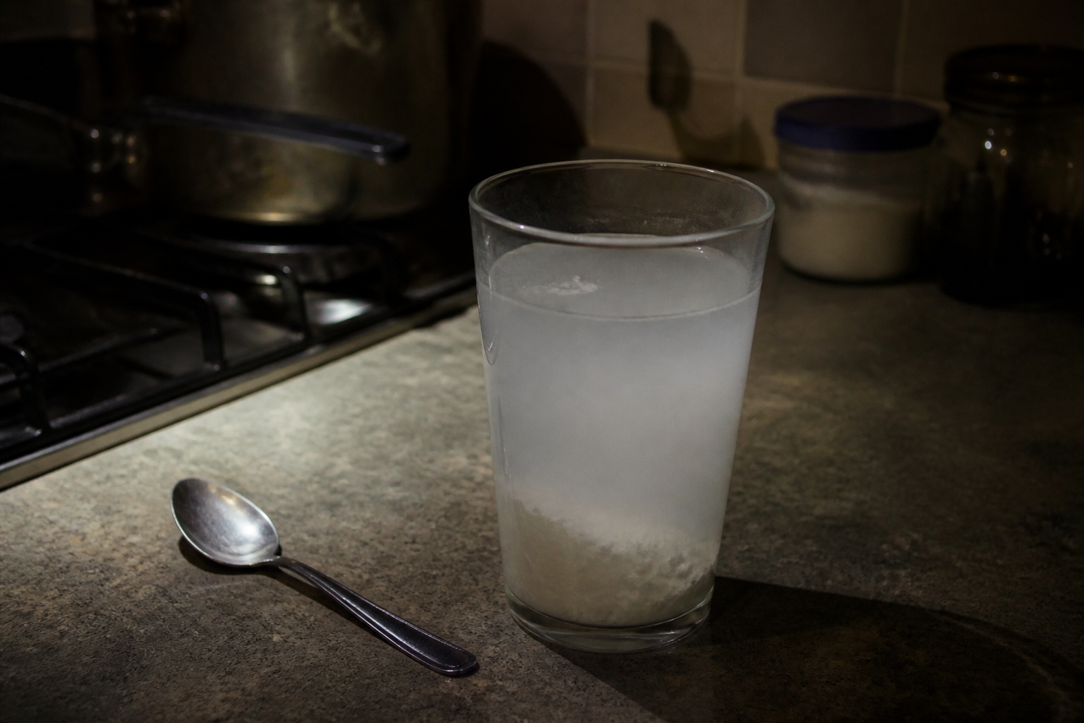 Cloudy magnesium drink on a kitchen counter at night